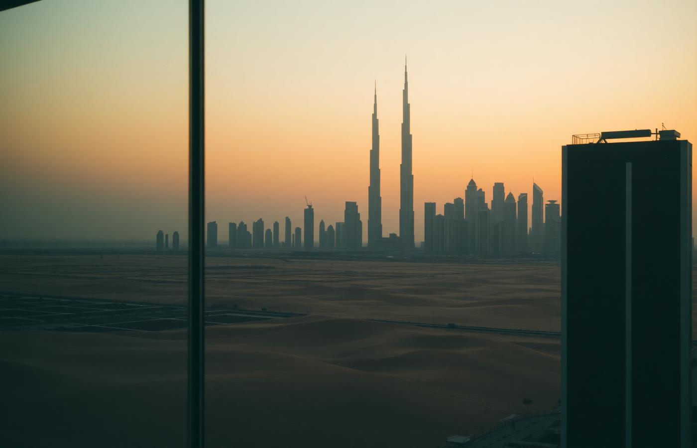 View of the Dubai skyline from an office window at dusk
